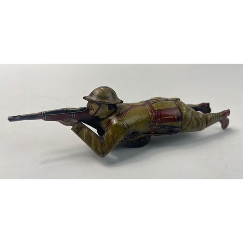 201 - Vintage EINFALT (Germany) lithographed tin-plate clockwork figure of a WW1 soldier depicted lying on... 