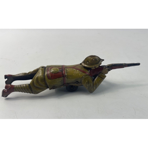 201 - Vintage EINFALT (Germany) lithographed tin-plate clockwork figure of a WW1 soldier depicted lying on... 