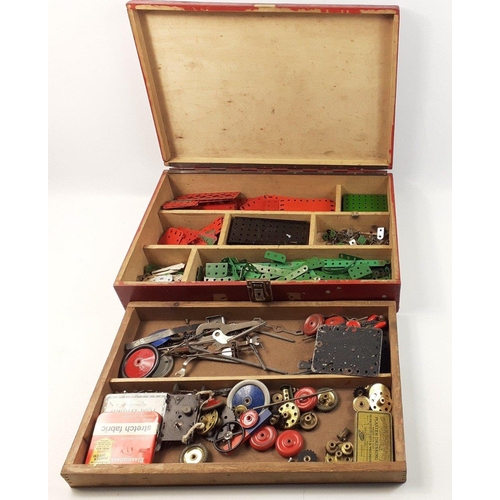 202 - A vintage wooden MECCANO chest containing a useful selection of red, green and brass components incl... 