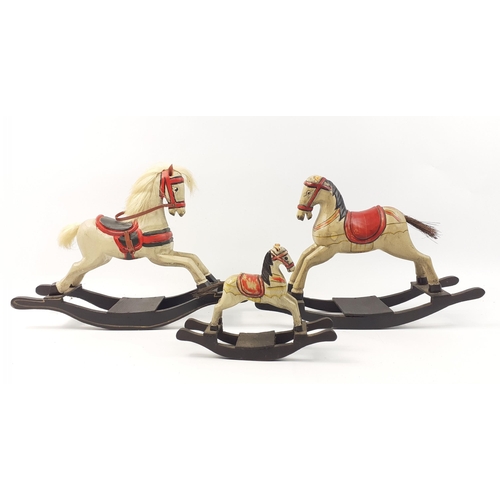 206 - A family of ornamental rocking horses, the tallest 20cm high.  One has had a close shave.#50