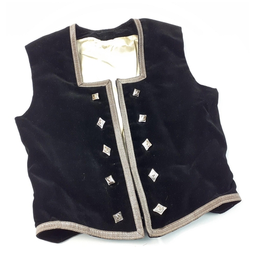 548 - A Highland dancing waistcoat in black velvet with cream satin lining and white metal buttons with th... 