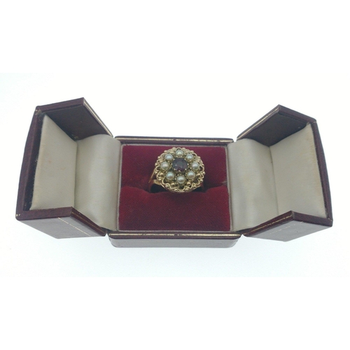 10 - An impressive large fully hallmarked 375 gold ring with a 7mm red ruby centre stone, and 7 pretty se... 