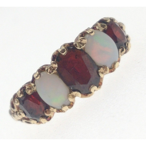 11 - A 375 fully hallmarked opal and garnet ring, largest centre stone measures 6mm approx, size O, gross... 