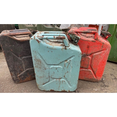 181 - THREE VINTAGE JERRY cans in varying colours - black, light blue (unusual) and red#183