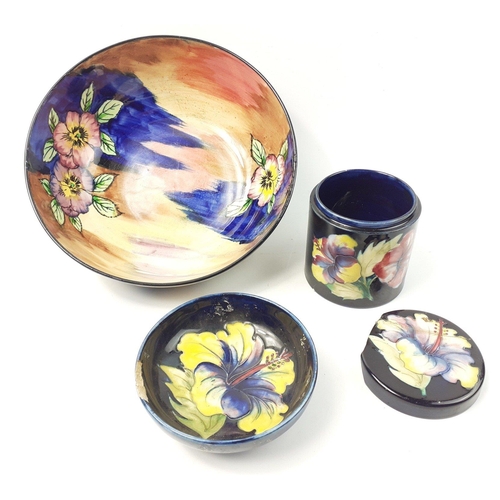 223 - An original early MOORCROFT 9cm jar with hibiscus pattern, base is in excellent condition and the li... 