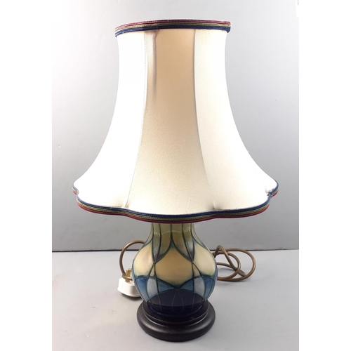 228 - A floral MOORCROFT baluster lamp standing 43cm high approx with a 20cm base, comes with a Moorcroft ... 