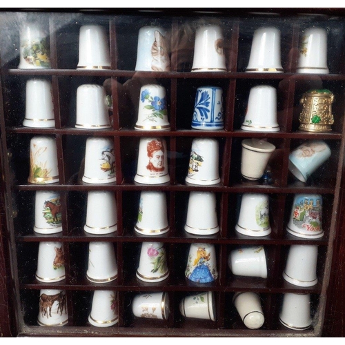 258 - Two small wall display cases containing over 40 collectable thimbles#260