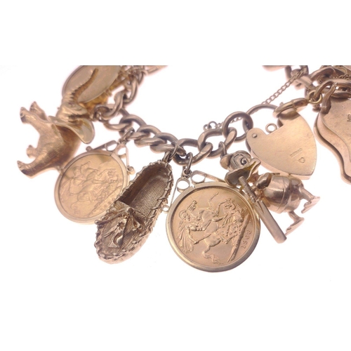 26 - A truly superlative gold charm bracelet set with no fewer than 6 full sovereigns mounted in 9ct gold... 