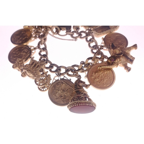 26 - A truly superlative gold charm bracelet set with no fewer than 6 full sovereigns mounted in 9ct gold... 