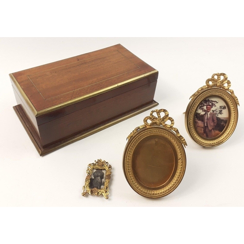 282 - A very attractive brass banded hinged vintage cigarette box containing 3 useful photo frames, the la... 