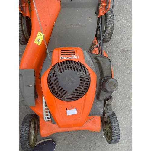 545 - A HUSQVARNA rear gear drive petrol lawnmower with grass bucket - lawnmower sitting in a garage and w... 