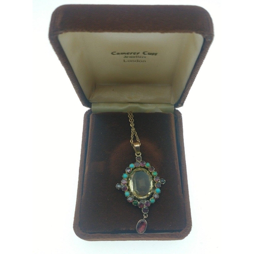 56 - A very pretty drop pendant with small turquoise and other stones and a large clear glass centre ston... 