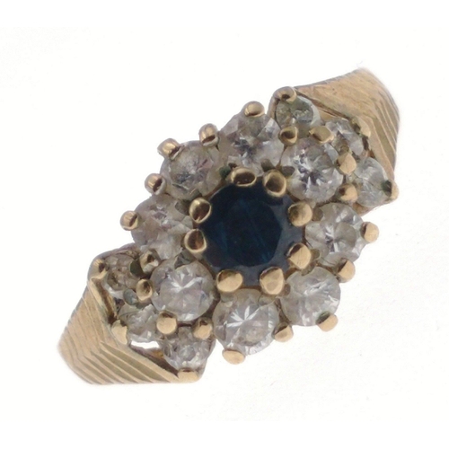 13 - A 9ct hallmarked gold ring size L, set with cubic zirconas and a central blue stone, gross weight 2.... 