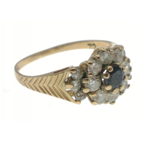 13 - A 9ct hallmarked gold ring size L, set with cubic zirconas and a central blue stone, gross weight 2.... 