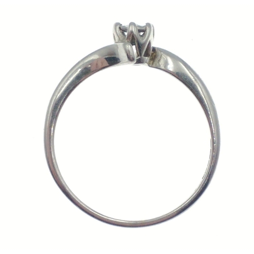 14 - A ring stamped 375 with white gold set with a solitaire diamond (tested), size K, gross weight 1.4g ... 