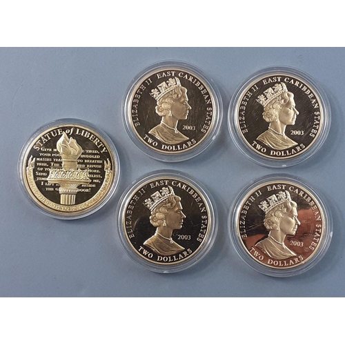 203 - A selection of Westminster Mint plated coins to include 1886 Liberty, Winston Churchill, Kitchener a... 