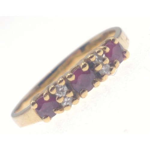 21 - A gold ring stamped 18 set with three garnets interspersed with small diamonds (tested). Size M Gros... 