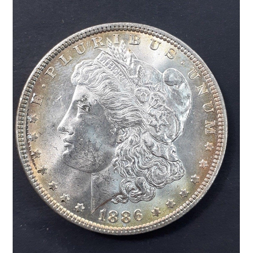 250 - 1886 UNITED STATES Morgan Dollar P. Toned and with unfortunate scratch to reverse.#250