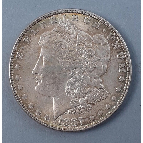 252 - USA Silver Coin. 1887 P Mint MORGAN DOLLAR in nice grade, Bright with light rainbow toning and good ... 