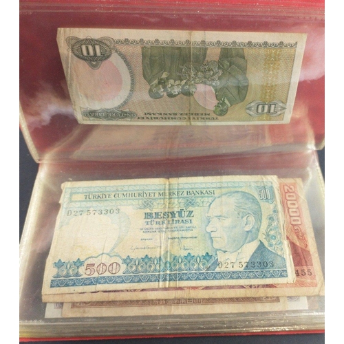 296 - An album containing world banknotes of interest to include Japanese Occupation note, China Hell note... 