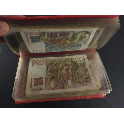 296 - An album containing world banknotes of interest to include Japanese Occupation note, China Hell note... 