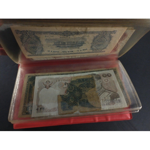 296 - An album containing world banknotes of interest to include Japanese Occupation note, China Hell note... 