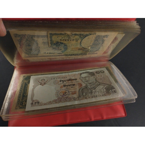 296 - An album containing world banknotes of interest to include Japanese Occupation note, China Hell note... 