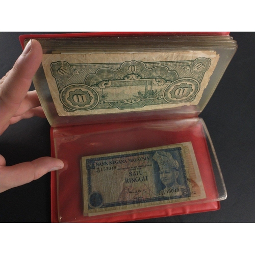 296 - An album containing world banknotes of interest to include Japanese Occupation note, China Hell note... 