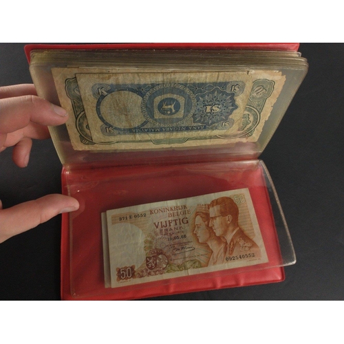 296 - An album containing world banknotes of interest to include Japanese Occupation note, China Hell note... 