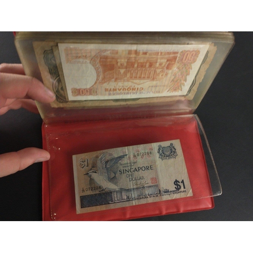 296 - An album containing world banknotes of interest to include Japanese Occupation note, China Hell note... 