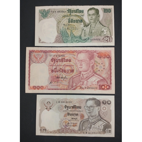 297 - A banknote album page containing three THAILAND banknotes of interest to include 100, 20, 10 Baht no... 