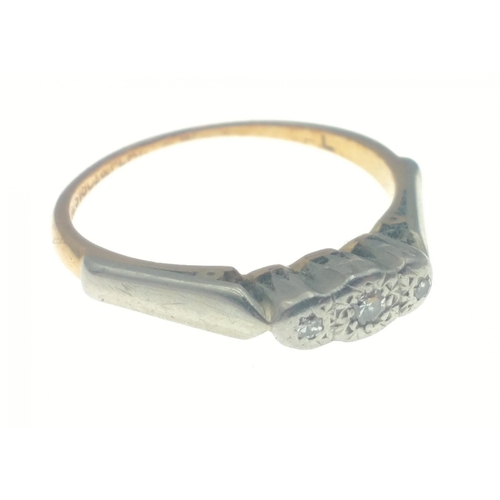 3 - An 18ct gold & platinum band set with three diamonds.  The largest centre stone 2mm approx.  Siz... 