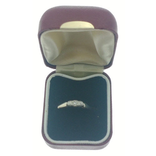 3 - An 18ct gold & platinum band set with three diamonds.  The largest centre stone 2mm approx.  Siz... 