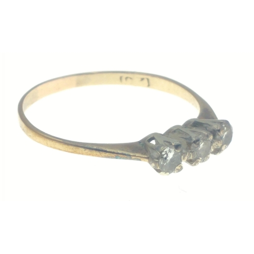 33 - A yellow metal ring with indistinct markings, set with three diamonds (tested), stones each approx 3... 