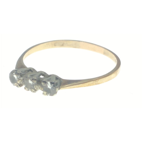 33 - A yellow metal ring with indistinct markings, set with three diamonds (tested), stones each approx 3... 