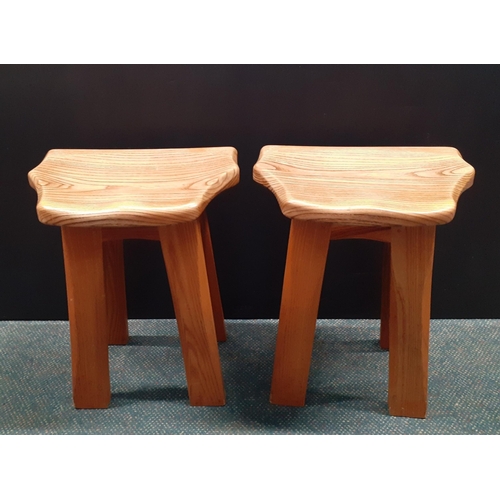 355 - From the workshop of TIM STEAD.  Two matched Elm Stools with shaped seat raised on four legs, each s... 