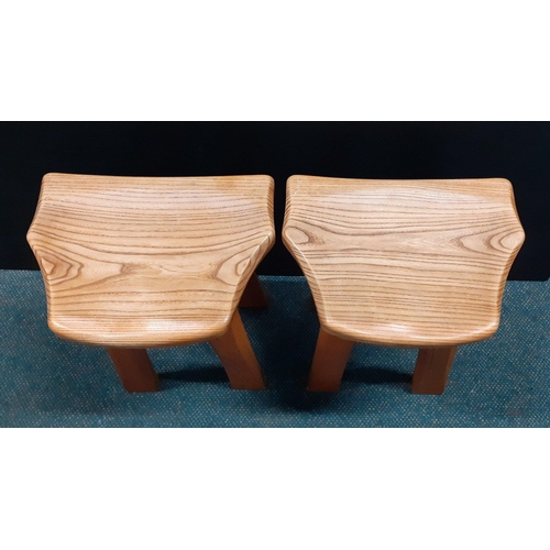 355 - From the workshop of TIM STEAD.  Two matched Elm Stools with shaped seat raised on four legs, each s... 