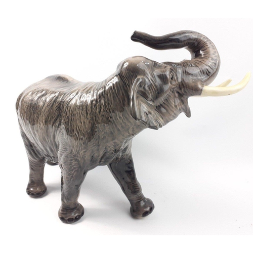 377 - A large BESWICK pottery elephant WITH TRUNK RAISED IN SALUTE, length 42cm x height 30cm approx - con... 