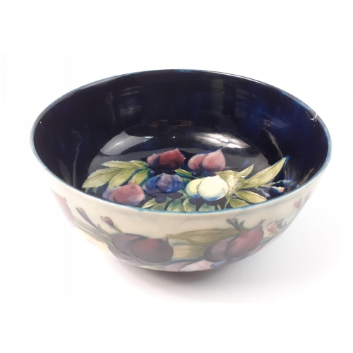 398 - A large Moorcroft fruit bowl with Moorcroft signature on base.  It is 24cm in diameter with an unfor... 