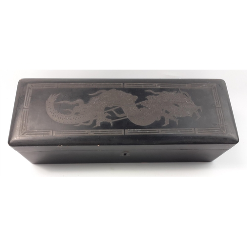 439 - An ORIENTAL rectangular black lacquered box with ornate DRAGON motif design on the top of the lid - ... 