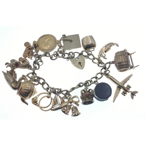 44 - Stunning charm bracelet - beautifully presented on a 9ct gold chain, each link stamped.  Charms incl... 