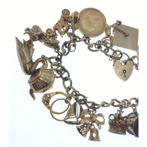 44 - Stunning charm bracelet - beautifully presented on a 9ct gold chain, each link stamped.  Charms incl... 