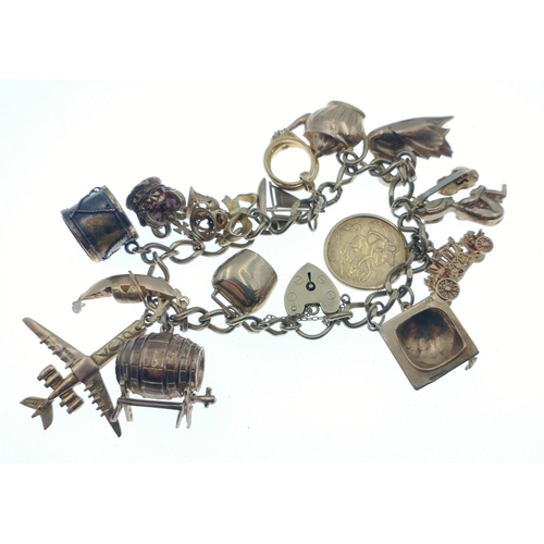 44 - Stunning charm bracelet - beautifully presented on a 9ct gold chain, each link stamped.  Charms incl... 