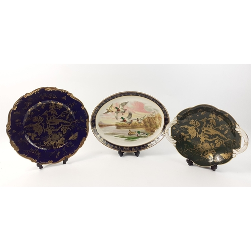 448 - Two COALPORT dishes with exotic birds one green and gilt and the larger cobalt blue and gilt 27cm di... 