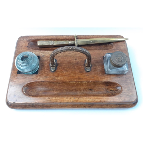 468 - An antique wooden desk stand.  30 x 20cm.  One bottle appears original.  Comes with a brass letter o... 