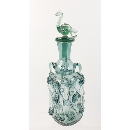 474 - A beautiful light green glass decanter with swan stopper standing 30cm tall.  In good order with ver... 