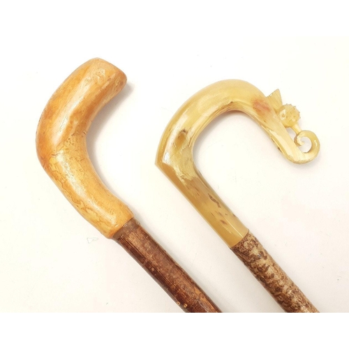 495 - Two shepherd's crooks one horn-handled with thistle motif, the other oversized (144cm long) for chin... 