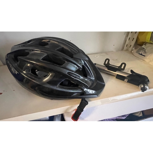 513 - A MET cycling helmet in black and grey with a handy bike hand pump#512