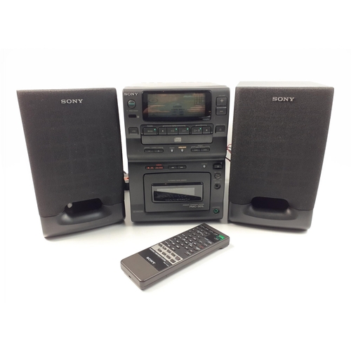 527 - A mini SONY music centre model PMC-301L complete with 2 speakers and remote.  Appears to be in excel... 