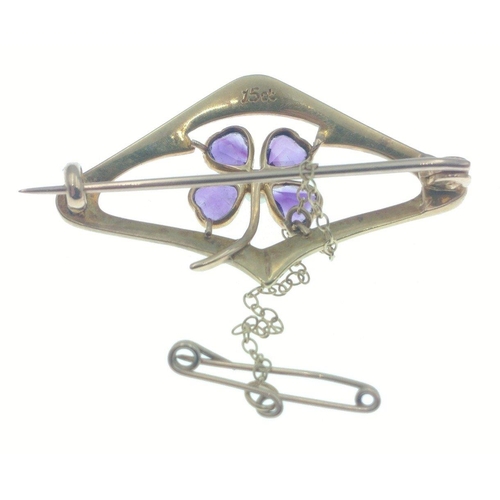 59 - A beautiful 15ct gold brooch with safety chain and set with seed pearls and 4 amethysts set in a luc... 